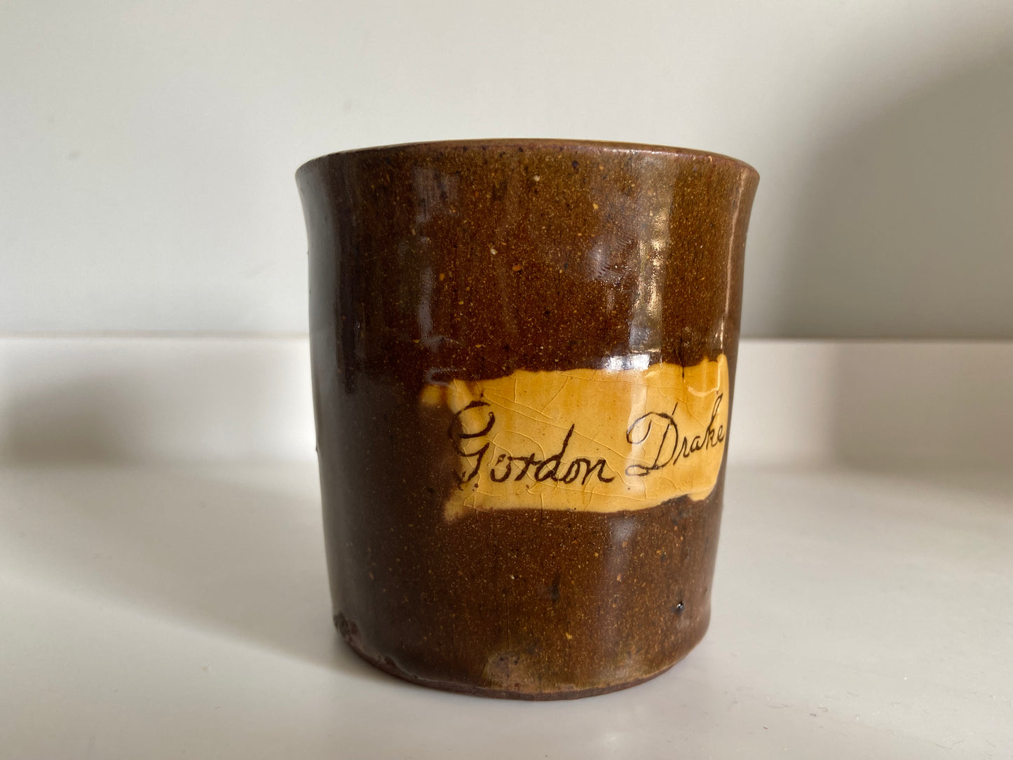 A slipware mug by Isaac Button of Soil Hill, Halifax