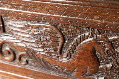 An  Elizabethan carved oak boarded chest with winged fantastic beasts, english, probably West Country, circa 1570–90