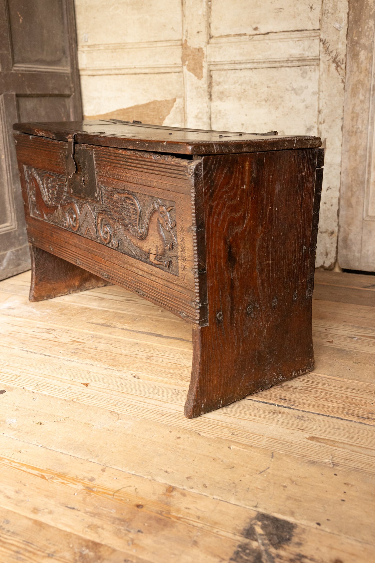 An  Elizabethan carved oak boarded chest with winged fantastic beasts, english, probably West Country, circa 1570–90