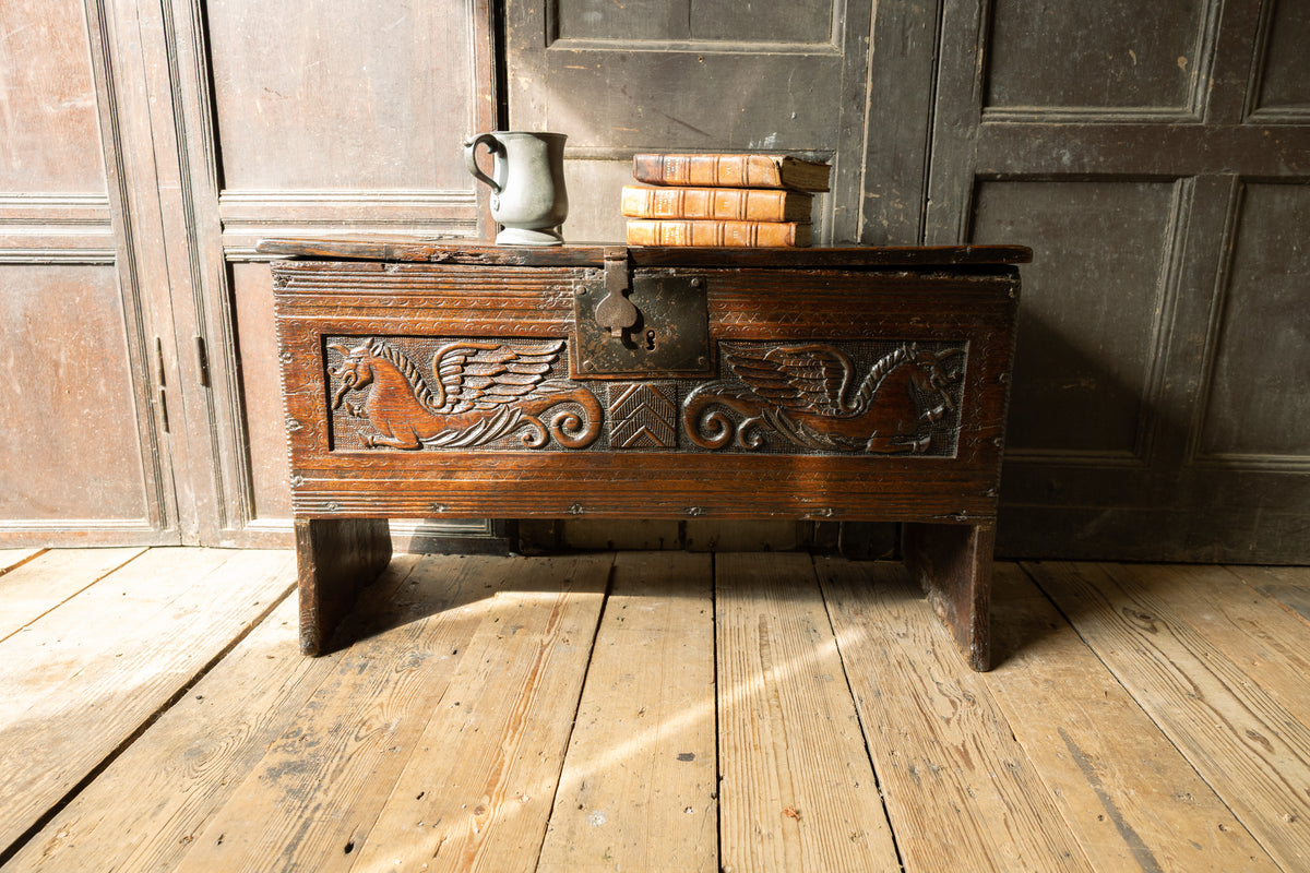 An  Elizabethan carved oak boarded chest with winged fantastic beasts, english, probably West Country, circa 1570–90