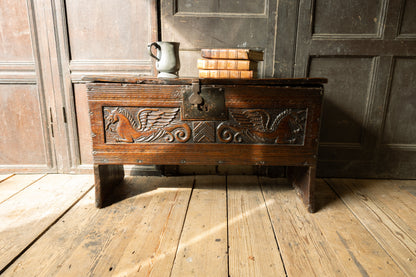 An  Elizabethan carved oak boarded chest with winged fantastic beasts, english, probably West Country, circa 1570–90