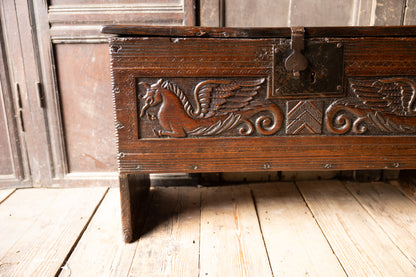 An  Elizabethan carved oak boarded chest with winged fantastic beasts, english, probably West Country, circa 1570–90