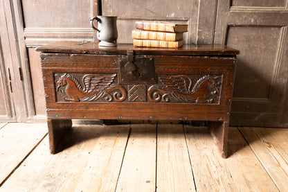 An  Elizabethan carved oak boarded chest with winged fantastic beasts, english, probably West Country, circa 1570–90