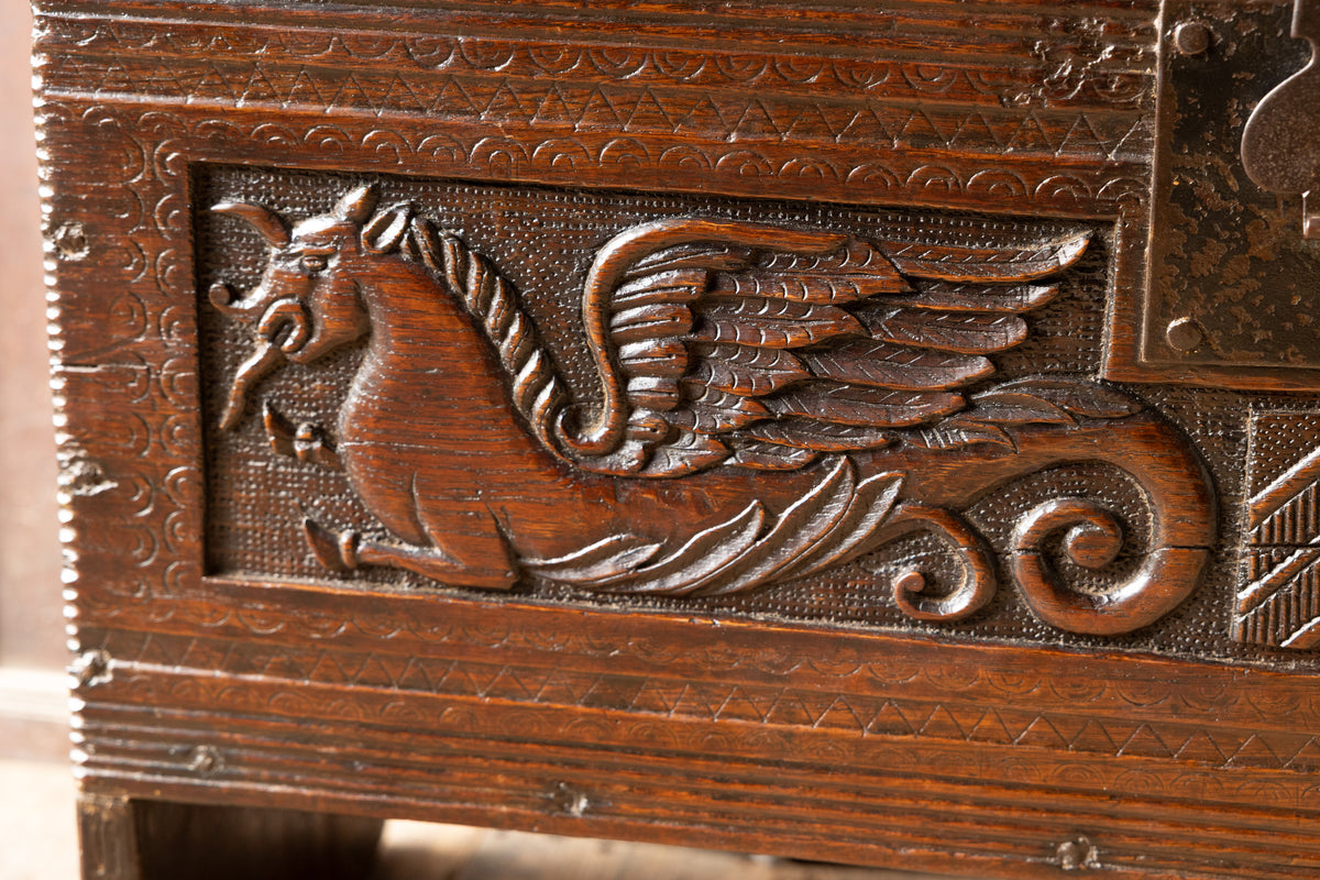 An  Elizabethan carved oak boarded chest with winged fantastic beasts, english, probably West Country, circa 1570–90