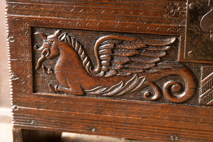 An  Elizabethan carved oak boarded chest with winged fantastic beasts, english, probably West Country, circa 1570–90
