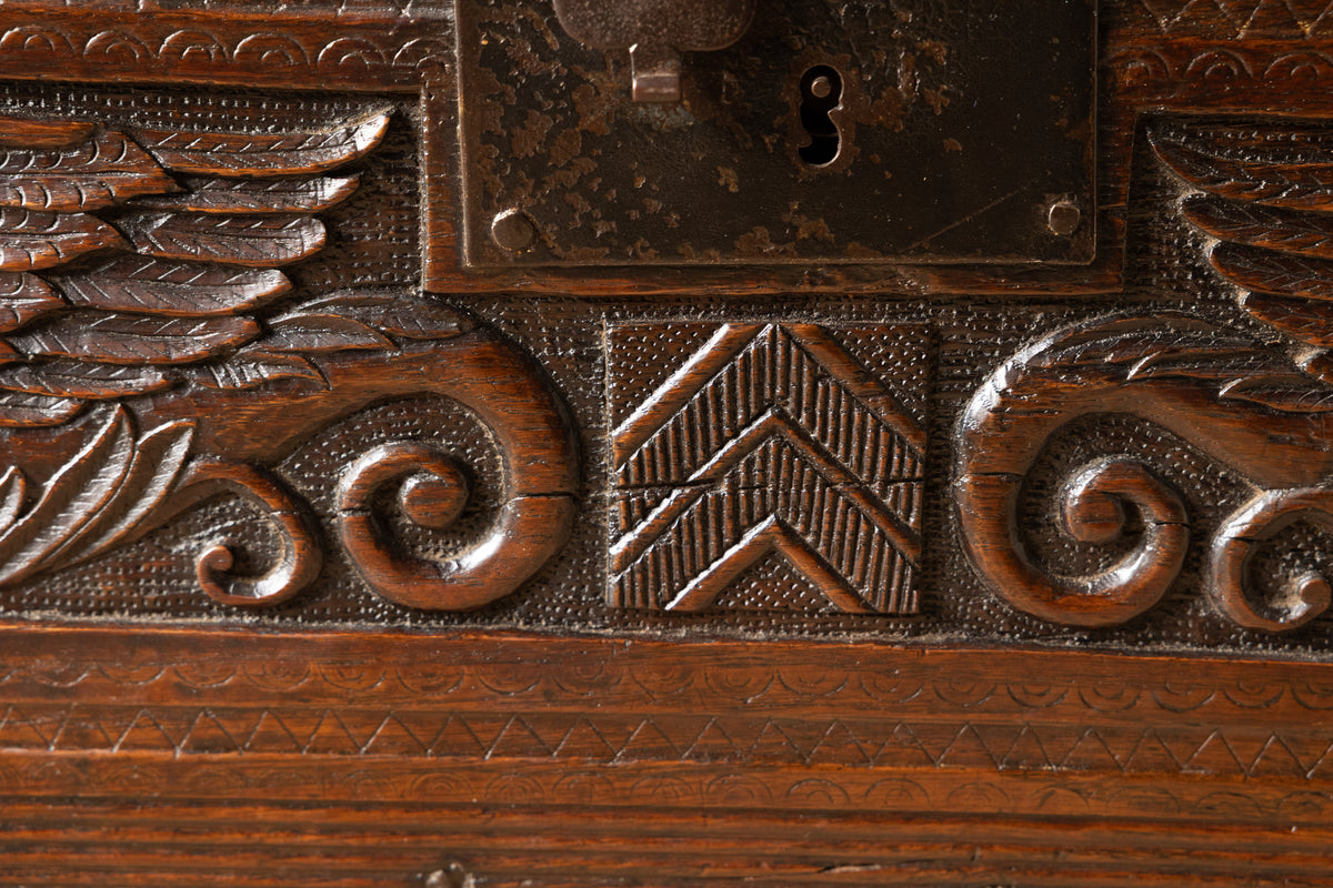 An  Elizabethan carved oak boarded chest with winged fantastic beasts, english, probably West Country, circa 1570–90