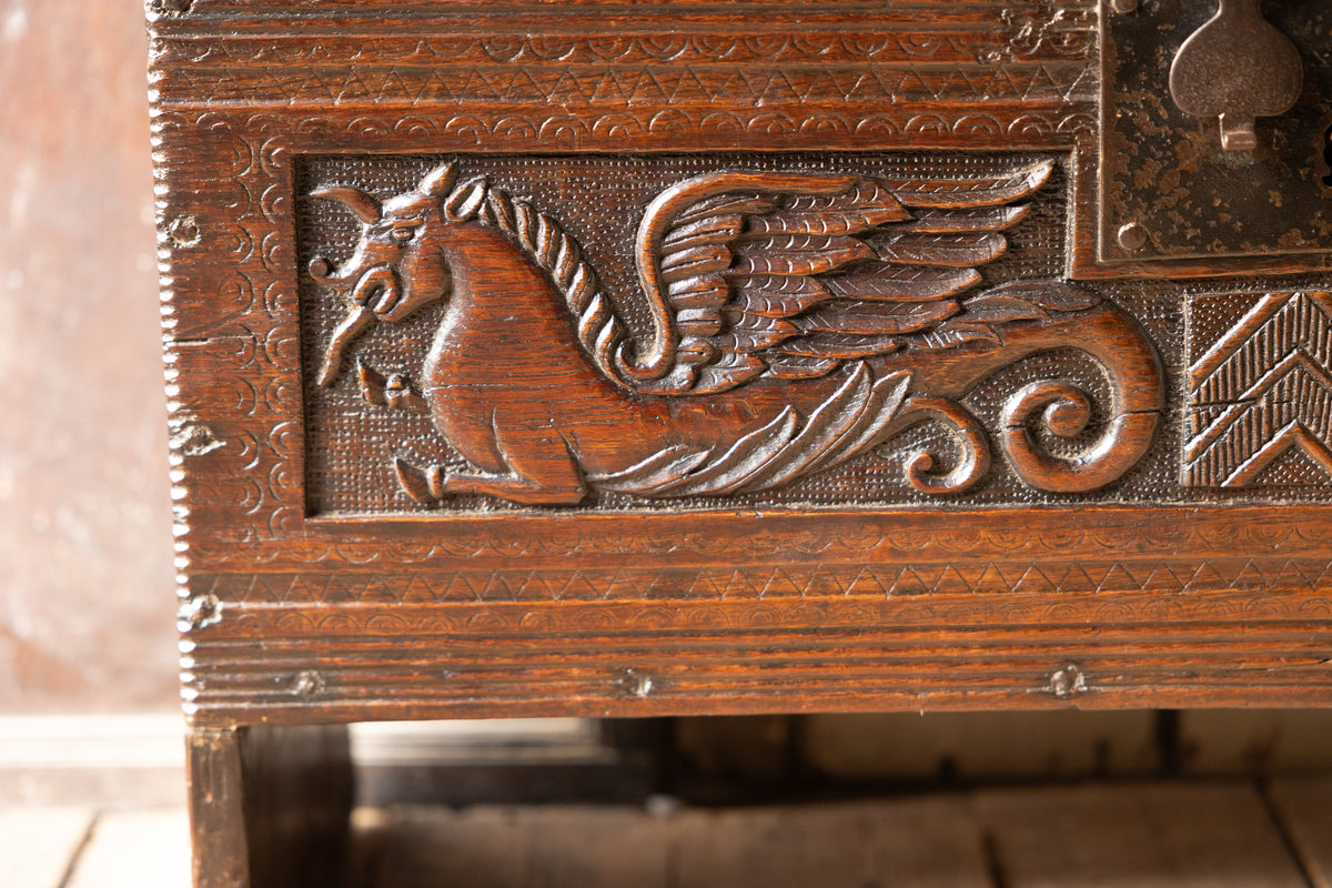 An  Elizabethan carved oak boarded chest with winged fantastic beasts, english, probably West Country, circa 1570–90