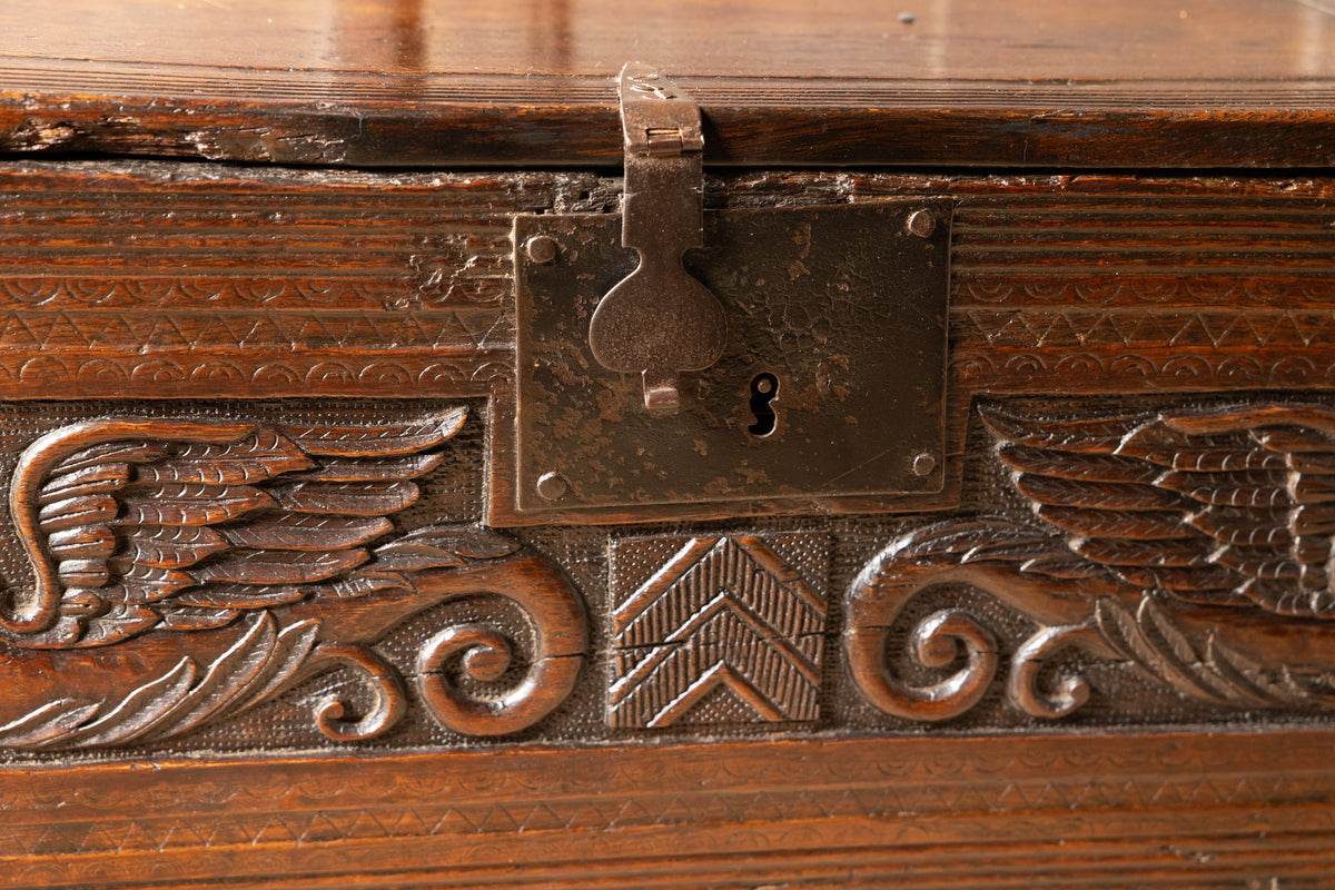 An  Elizabethan carved oak boarded chest with winged fantastic beasts, english, probably West Country, circa 1570–90