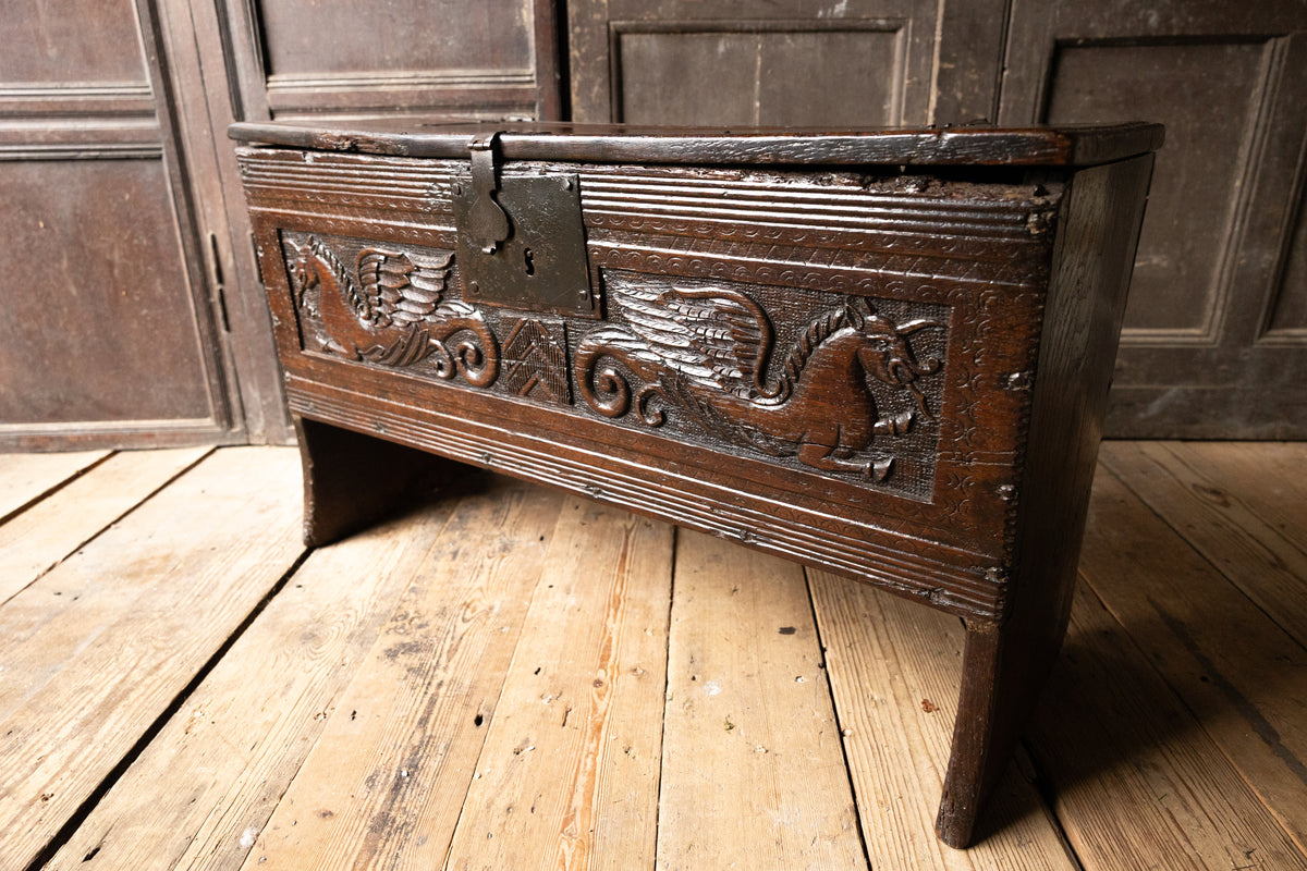 An  Elizabethan carved oak boarded chest with winged fantastic beasts, english, probably West Country, circa 1570–90