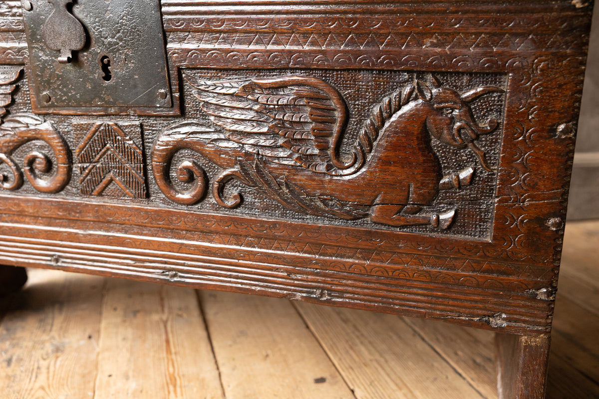 An  Elizabethan carved oak boarded chest with winged fantastic beasts, english, probably West Country, circa 1570–90