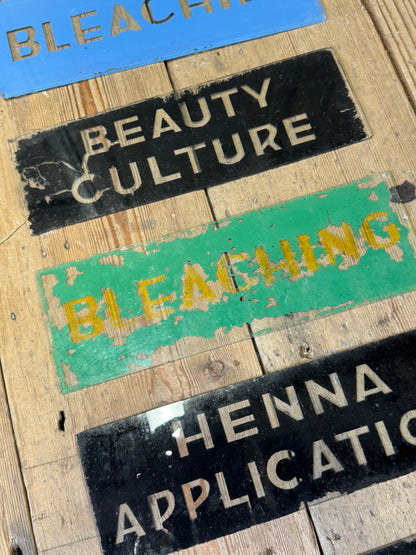 An unusual collection of fourteen reverse-painted glass signs from a hairdressing and beauty establishment c. 1930s/1940s