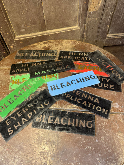 An unusual collection of fourteen reverse-painted glass signs from a hairdressing and beauty establishment c. 1930s/1940s