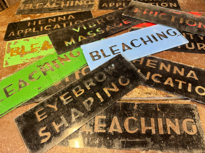 An unusual collection of fourteen reverse-painted glass signs from a hairdressing and beauty establishment c. 1930s/1940s