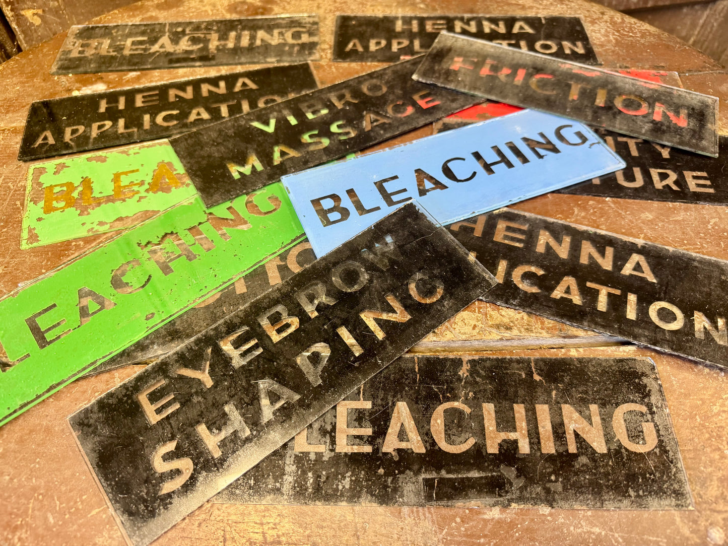 An unusual collection of fourteen reverse-painted glass signs from a hairdressing and beauty establishment c. 1930s/1940s
