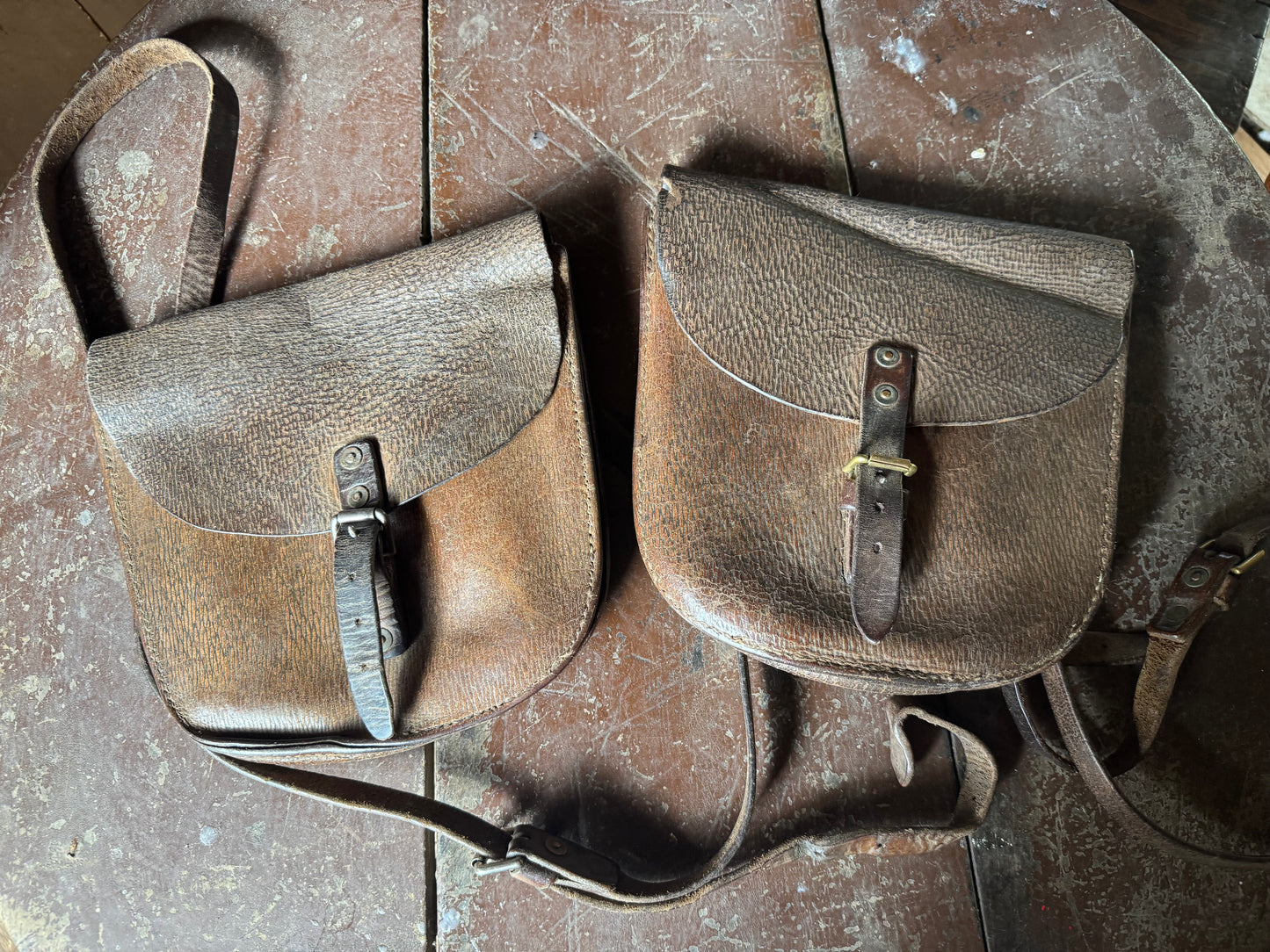 A pair of early 20th century leather despatch-type shoulder bags with original straps