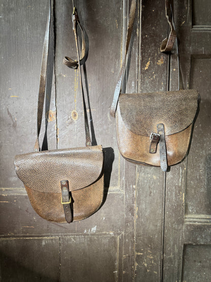 A pair of early 20th century leather despatch-type shoulder bags with original straps