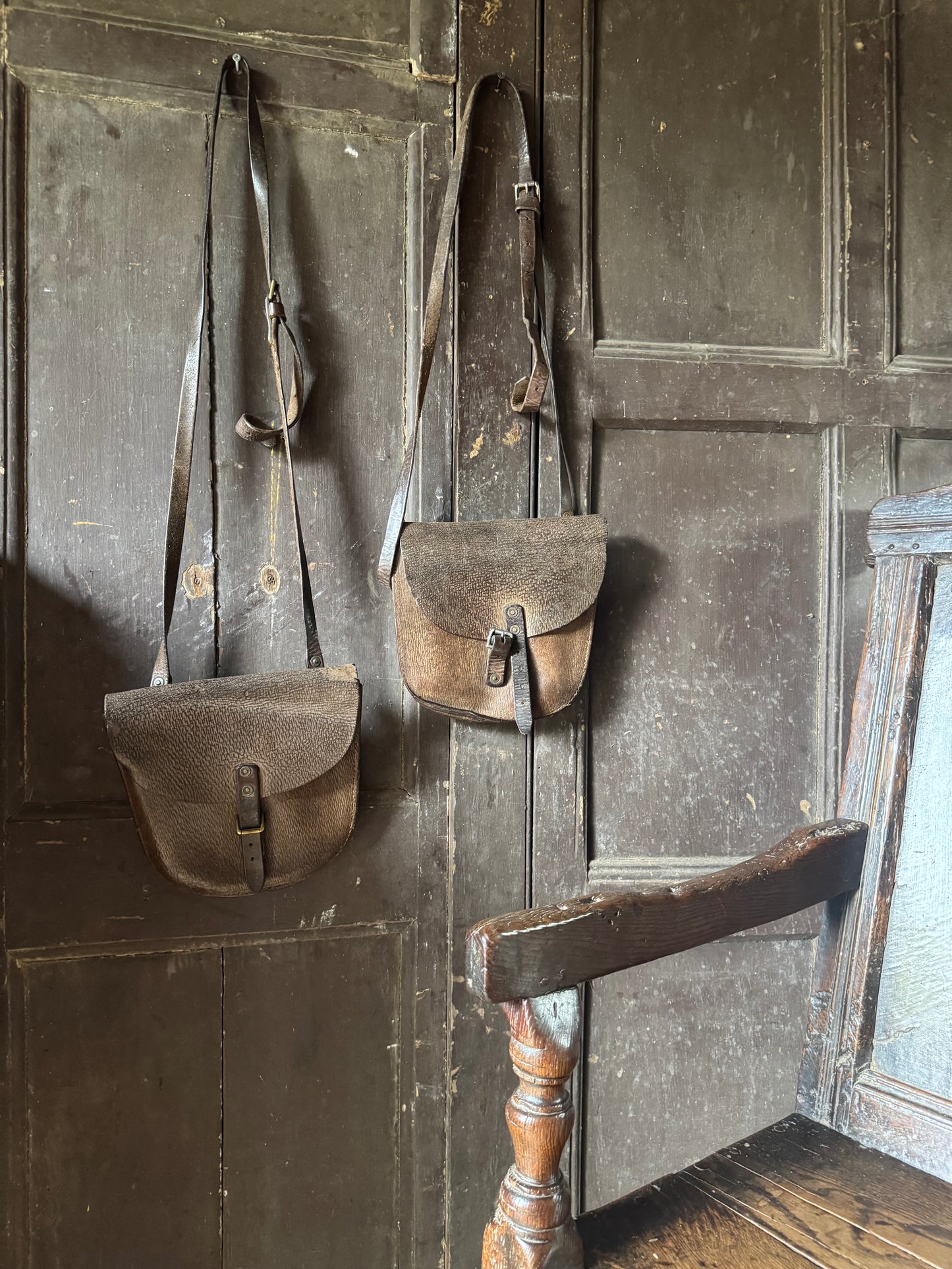 A pair of early 20th century leather despatch-type shoulder bags with original straps
