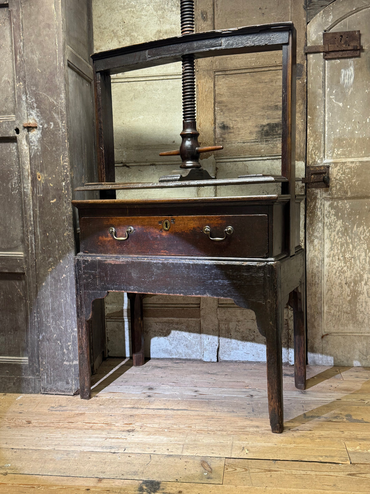 A provincial George III linen press with screw mechanism