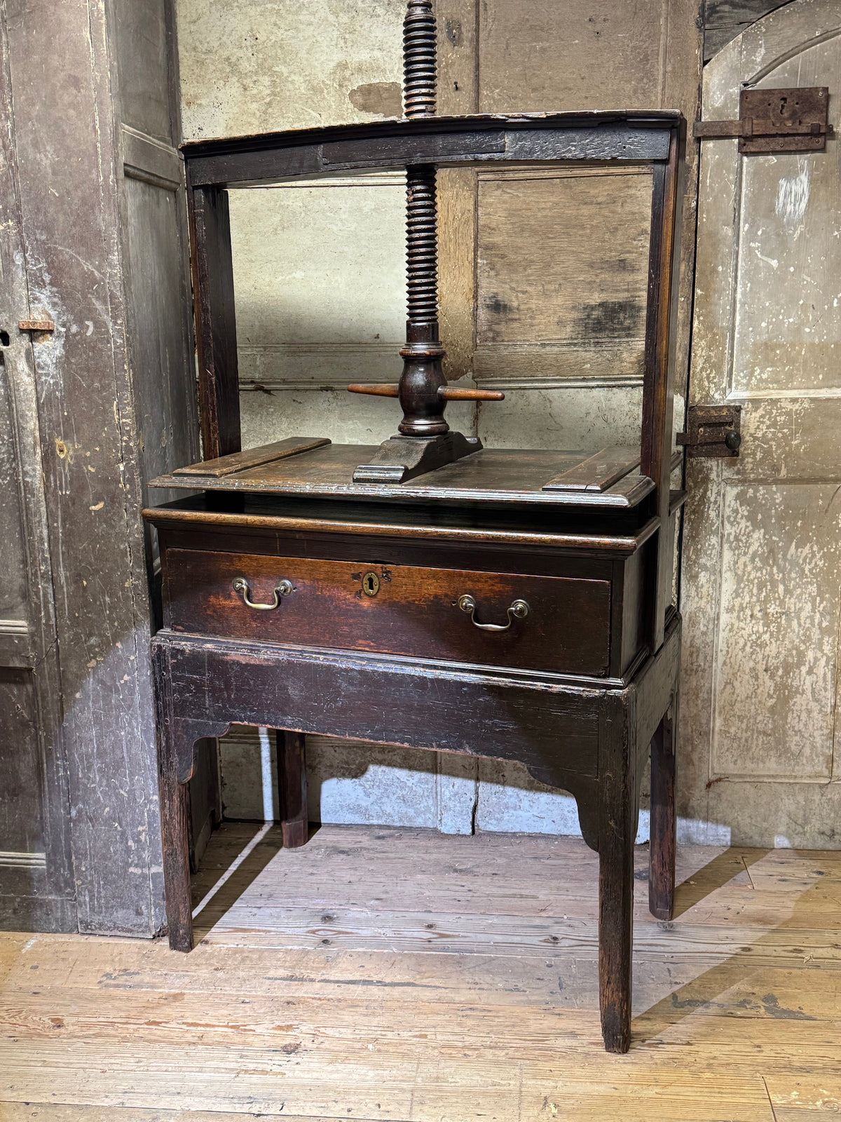 A provincial George III linen press with screw mechanism