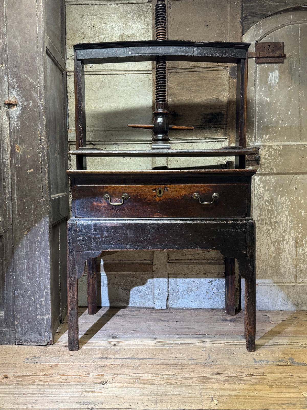 A provincial George III linen press with screw mechanism