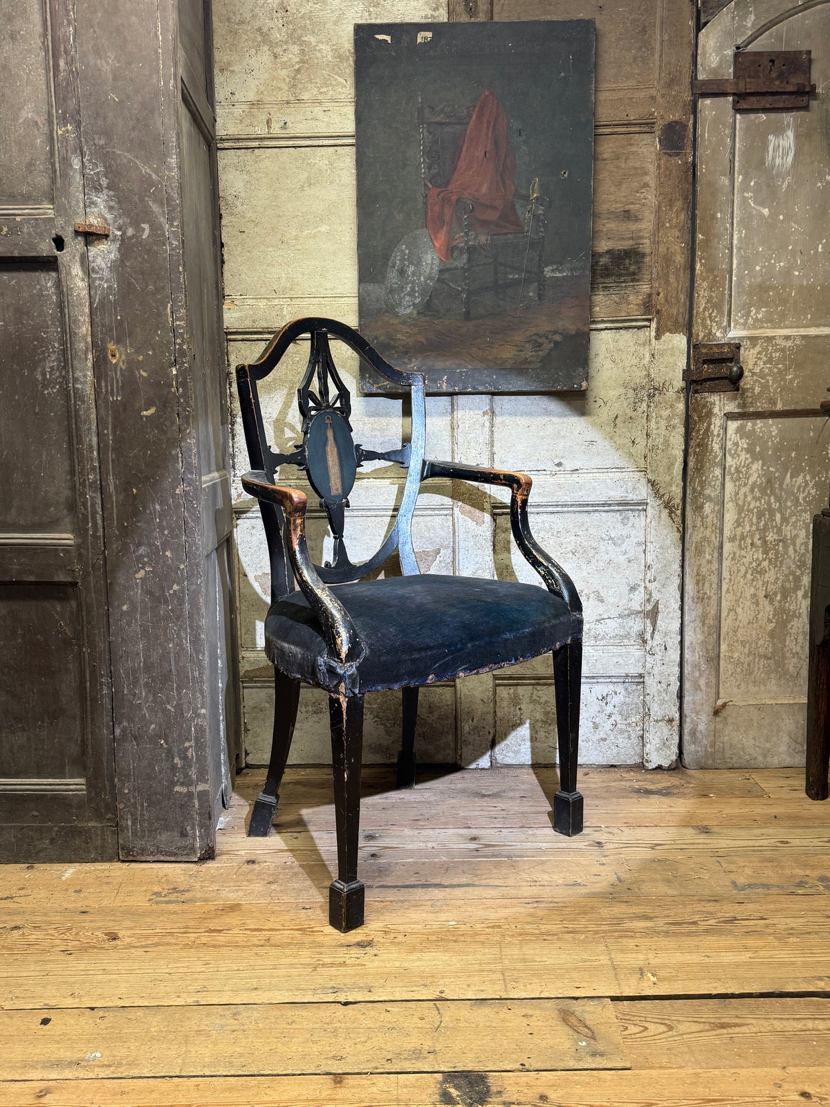 A late 18th-century George III painted open armchair with unusual block feet