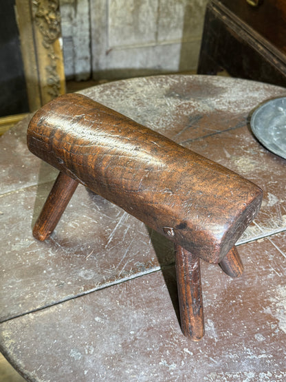 An unusual diminutive vernacular stool with sculpted rounded seat c.1800