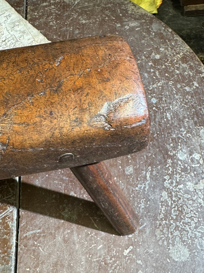 An unusual diminutive vernacular stool with sculpted rounded seat c.1800