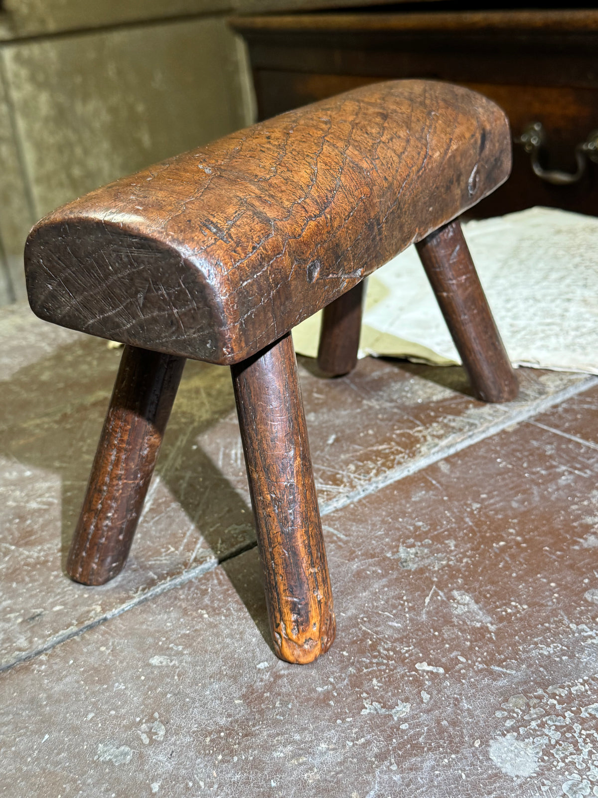 An unusual diminutive vernacular stool with sculpted rounded seat c.1800