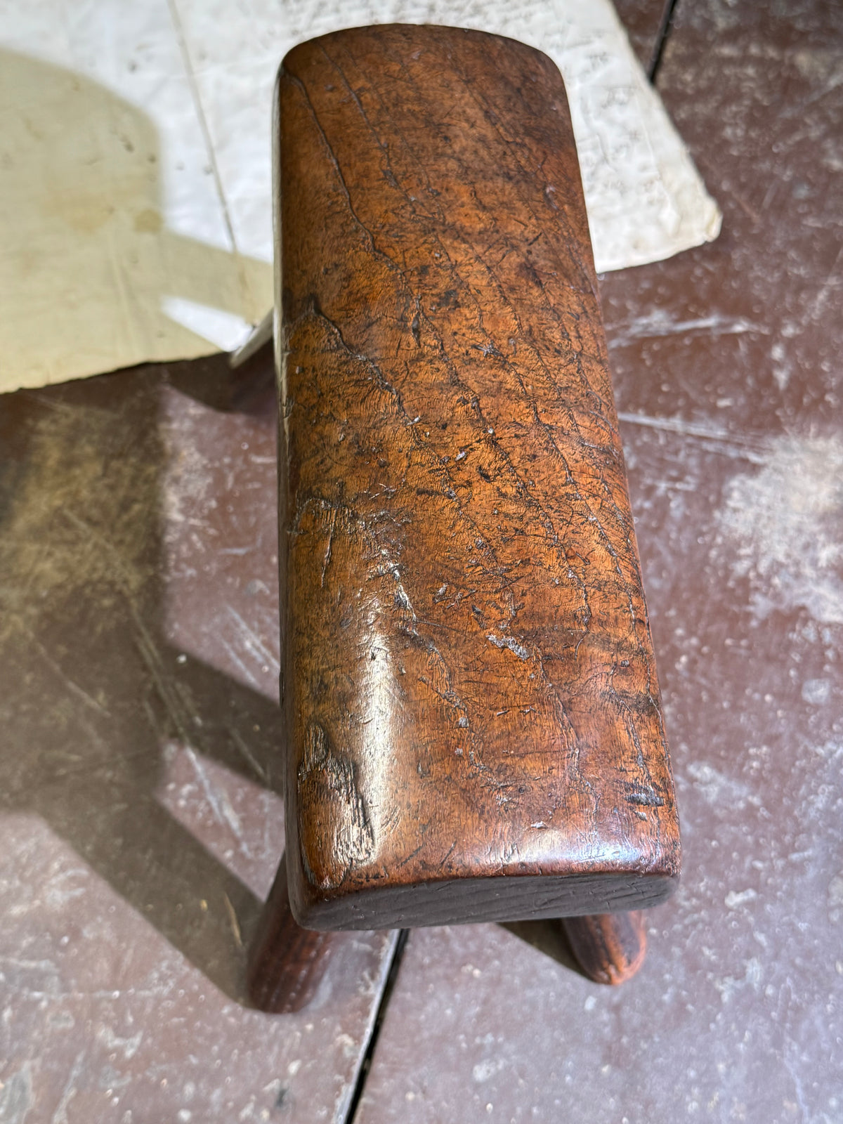 An unusual diminutive vernacular stool with sculpted rounded seat c.1800