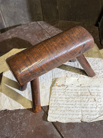 An unusual diminutive vernacular stool with sculpted rounded seat c.1800