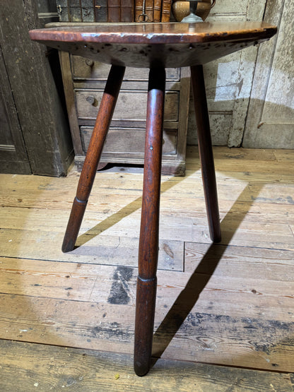 A George III primitive oak slab top octagonal cricket table of exceptional colour