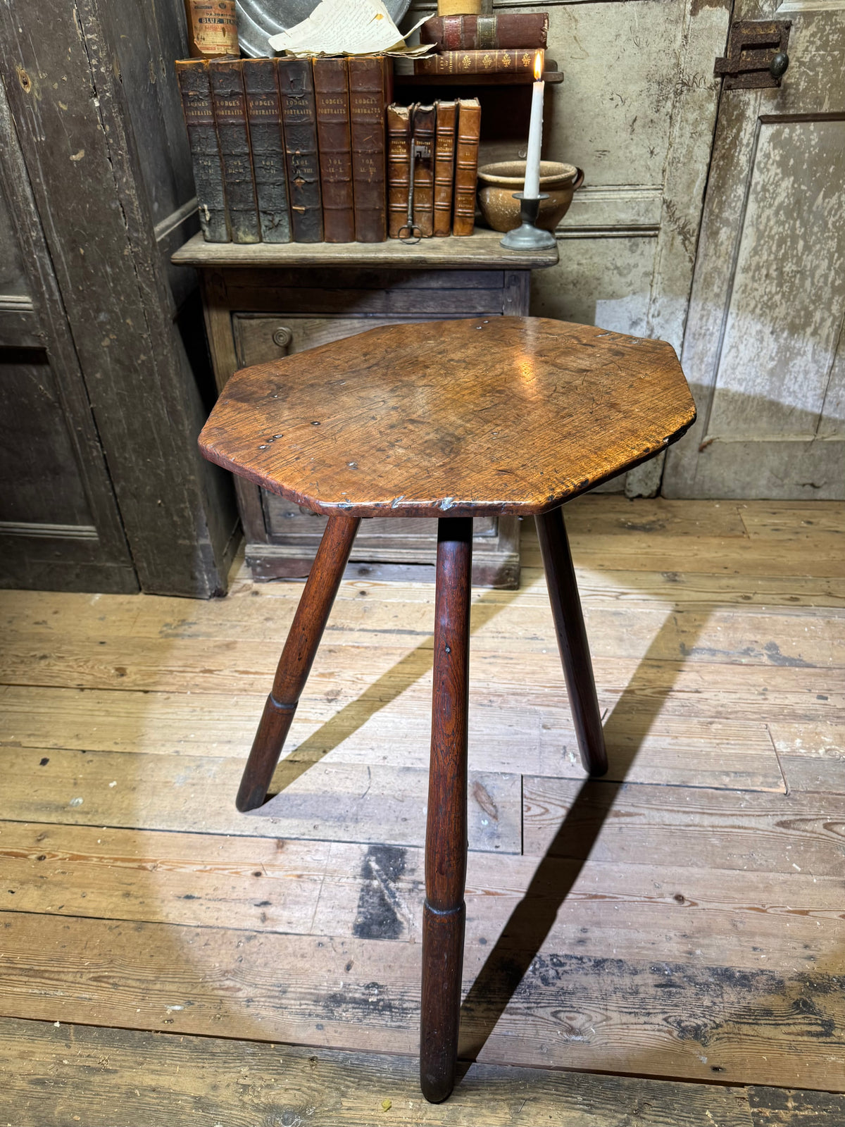 A George III primitive oak slab top octagonal cricket table of exceptional colour