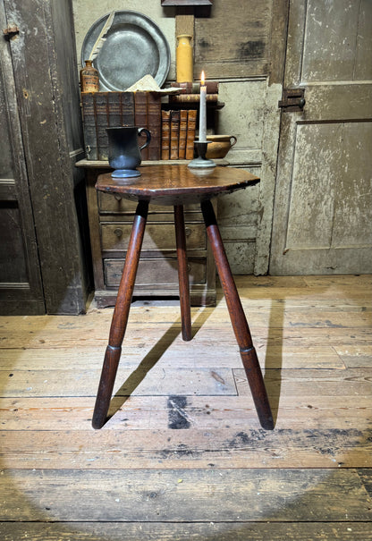 A George III primitive oak slab top octagonal cricket table of exceptional colour