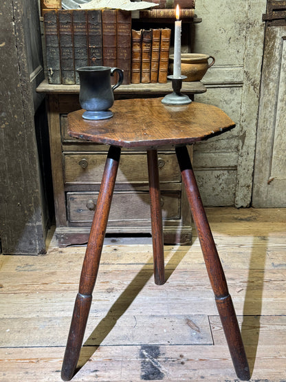 A George III primitive oak slab top octagonal cricket table of exceptional colour