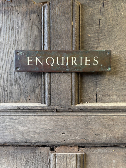 An early 20th century English 'Enquiries' brass door sign