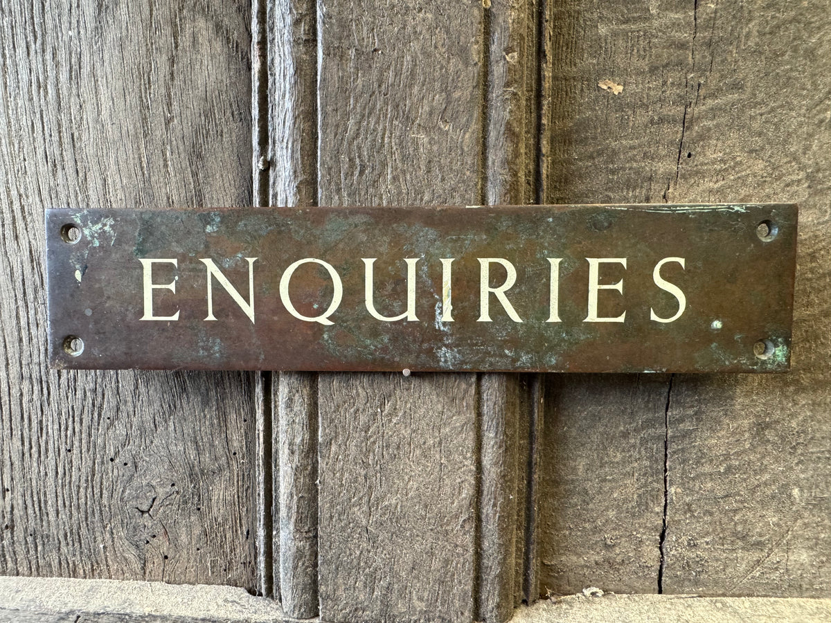 An early 20th century English 'Enquiries' brass door sign