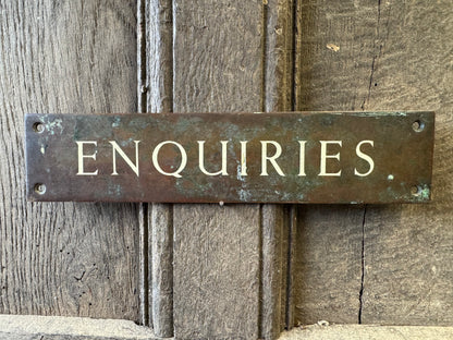 An early 20th century English 'Enquiries' brass door sign