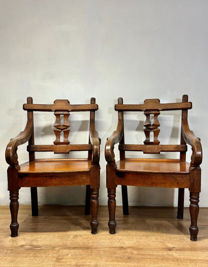 A pair of 19th century Welsh pitch pine chairs with unusual splats
