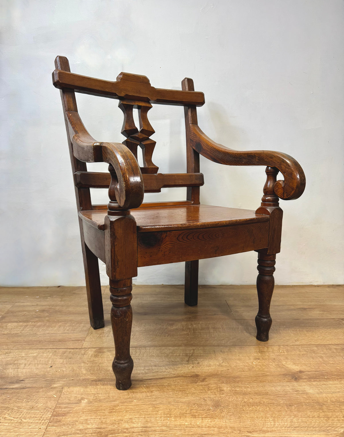 A pair of 19th century Welsh pitch pine chairs with unusual splats