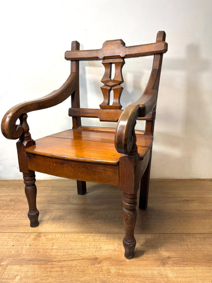 A pair of 19th century Welsh pitch pine chairs with unusual splats