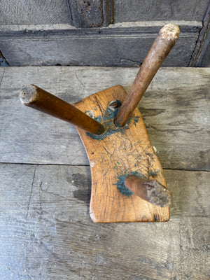 An 18th century elm slab top stool standing over three legs