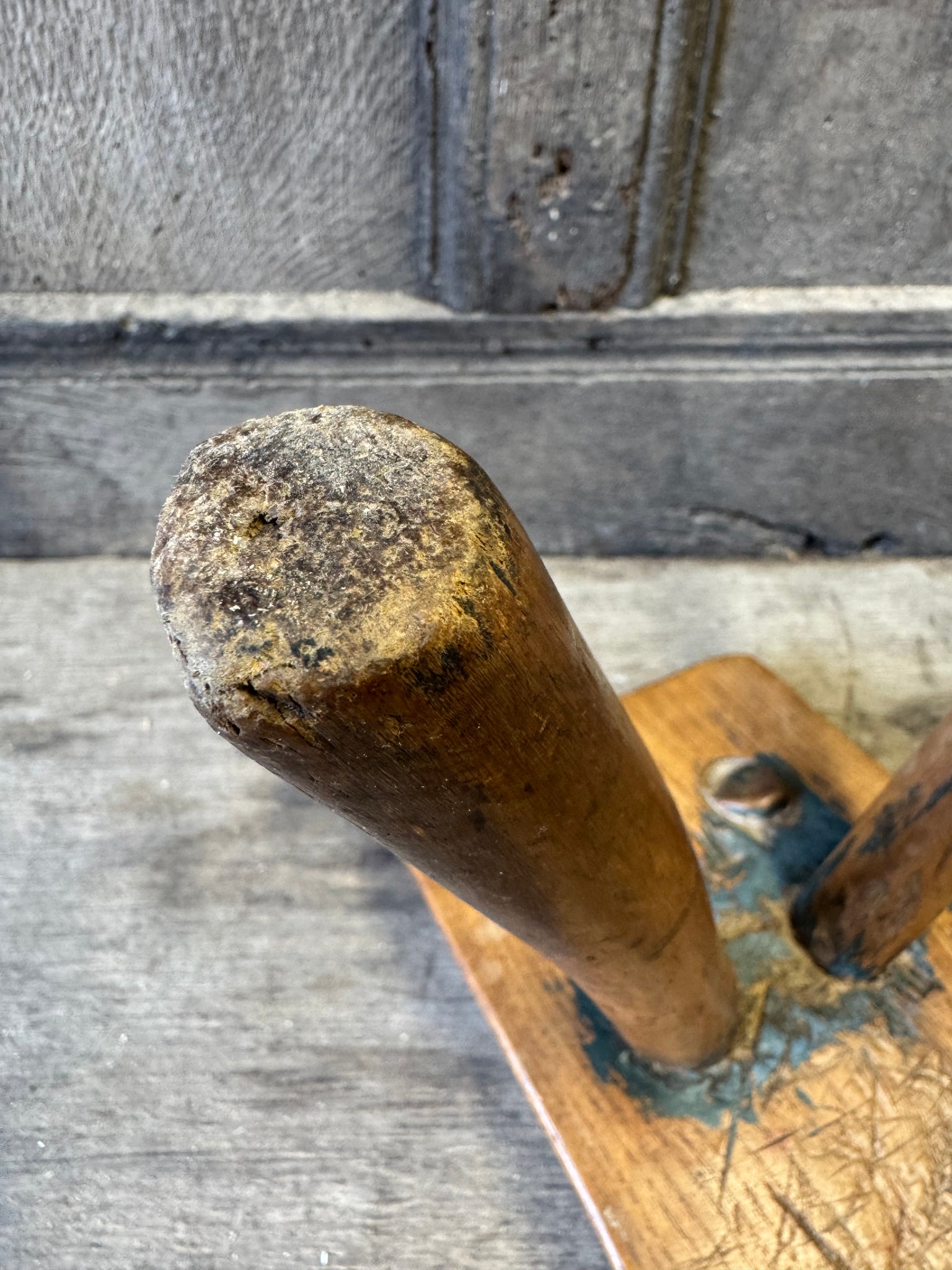 An 18th century elm slab top stool standing over three legs