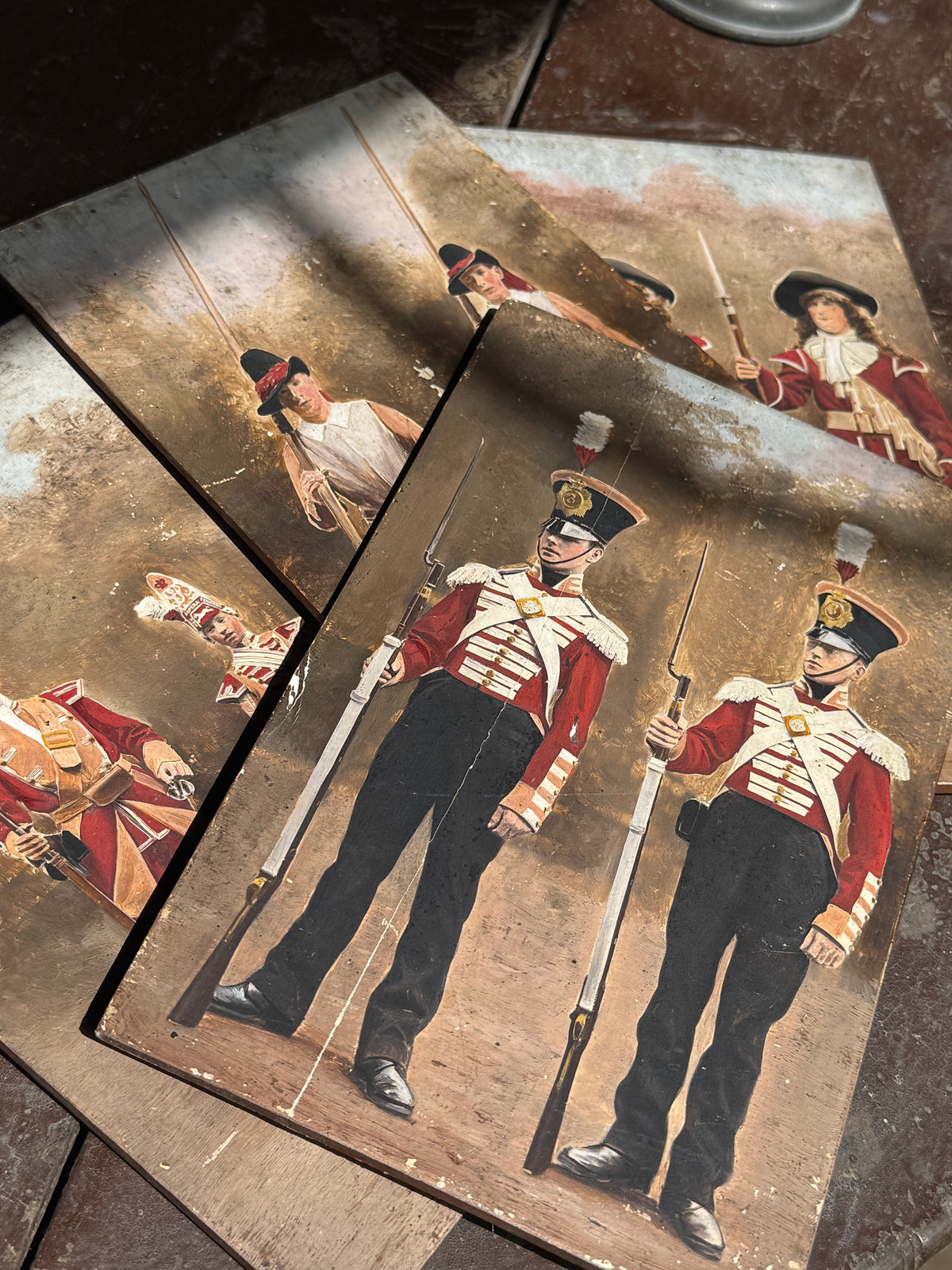 An unusual set of 4 early 20th century painted soldiers on panel