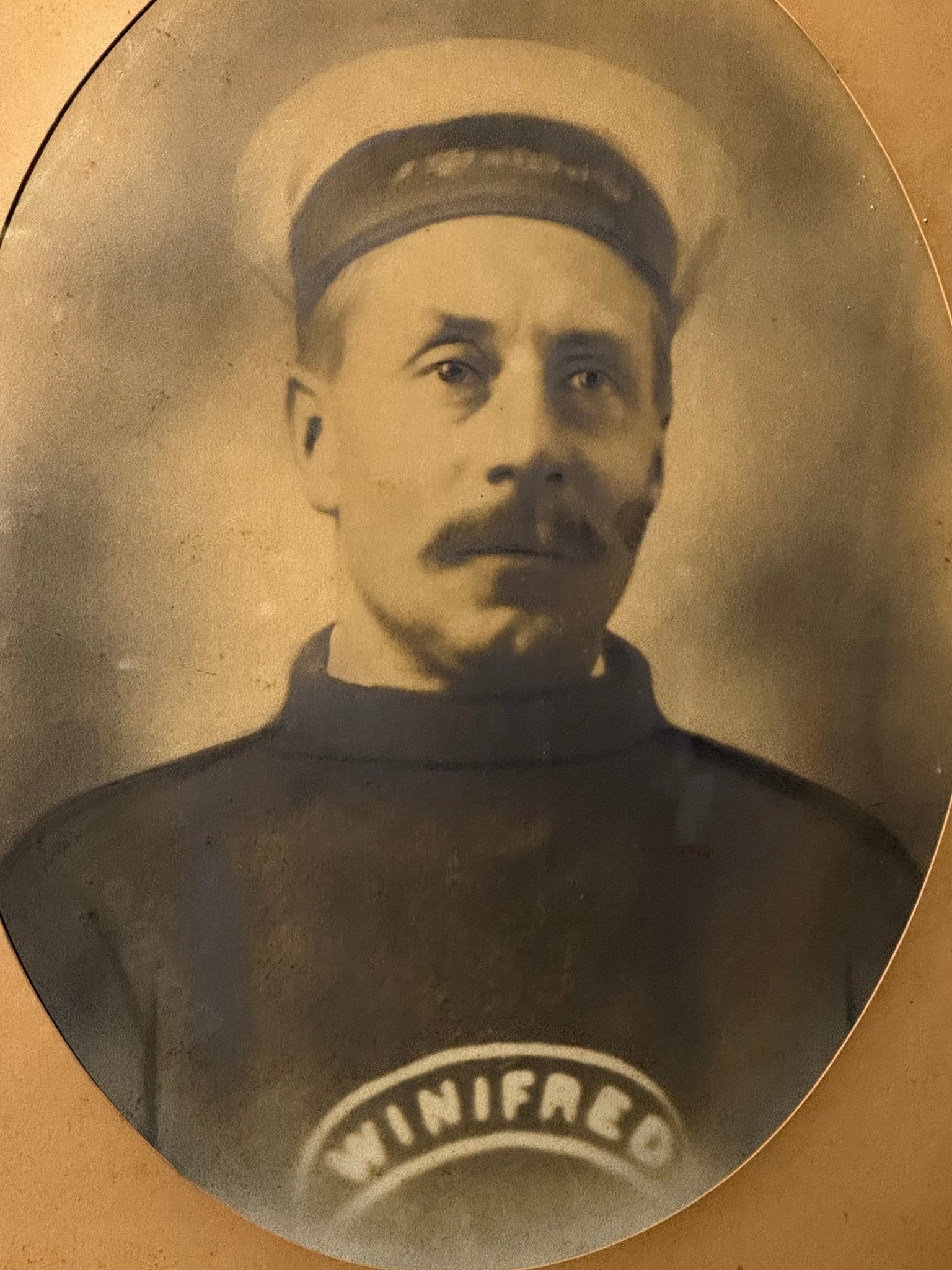 A large photograph on card of a sailor of the vessel Winifred, c.1900–1920s