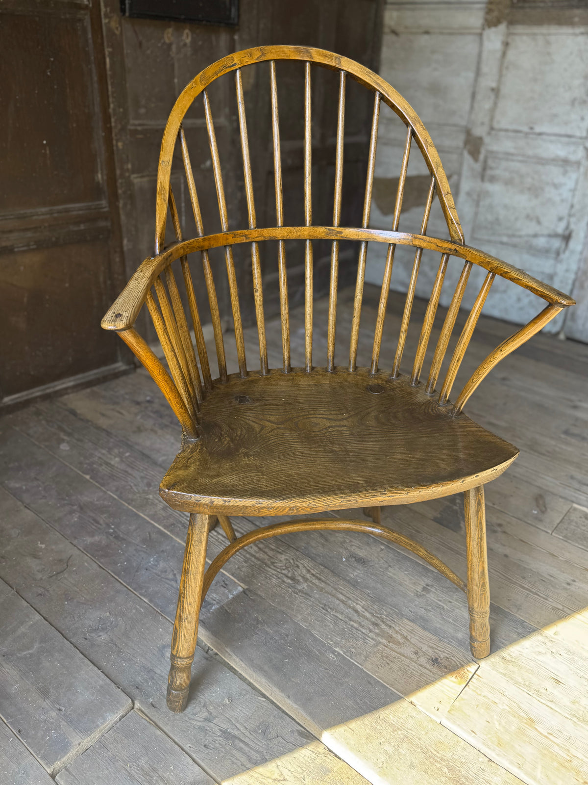 A George III West Country elm & ash Windsor armchair with crinoline  stretcher, c.1800–1820