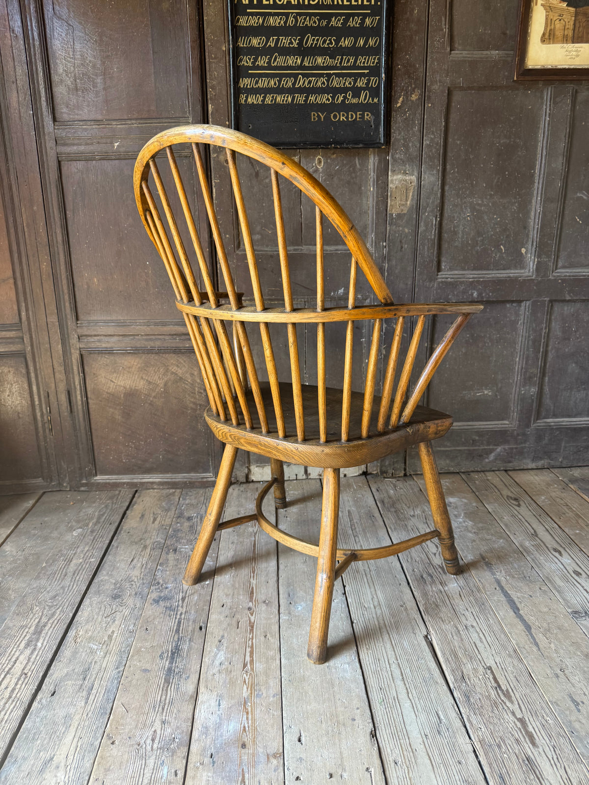 A George III West Country elm & ash Windsor armchair with crinoline  stretcher, c.1800–1820