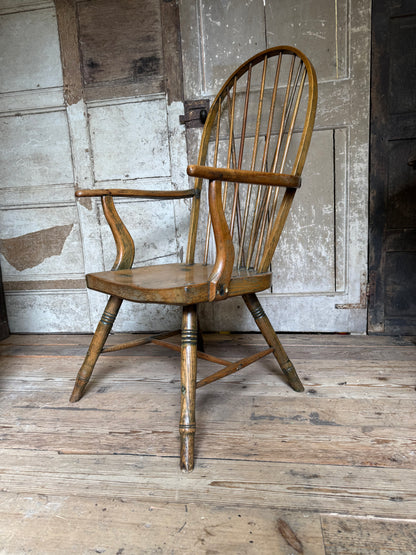An unusual George III elm and ash high hoop-back Windsor armchair, probably West Country, circa 1800