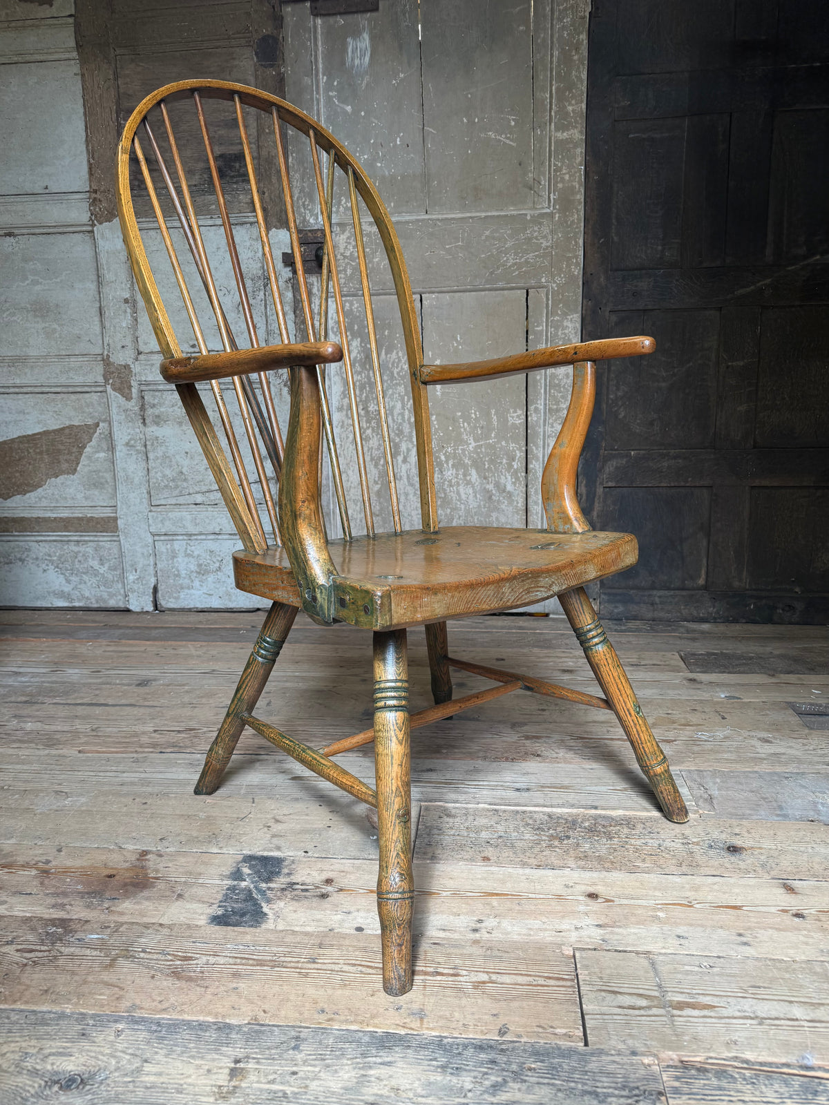 An unusual George III elm and ash high hoop-back Windsor armchair, probably West Country, circa 1800