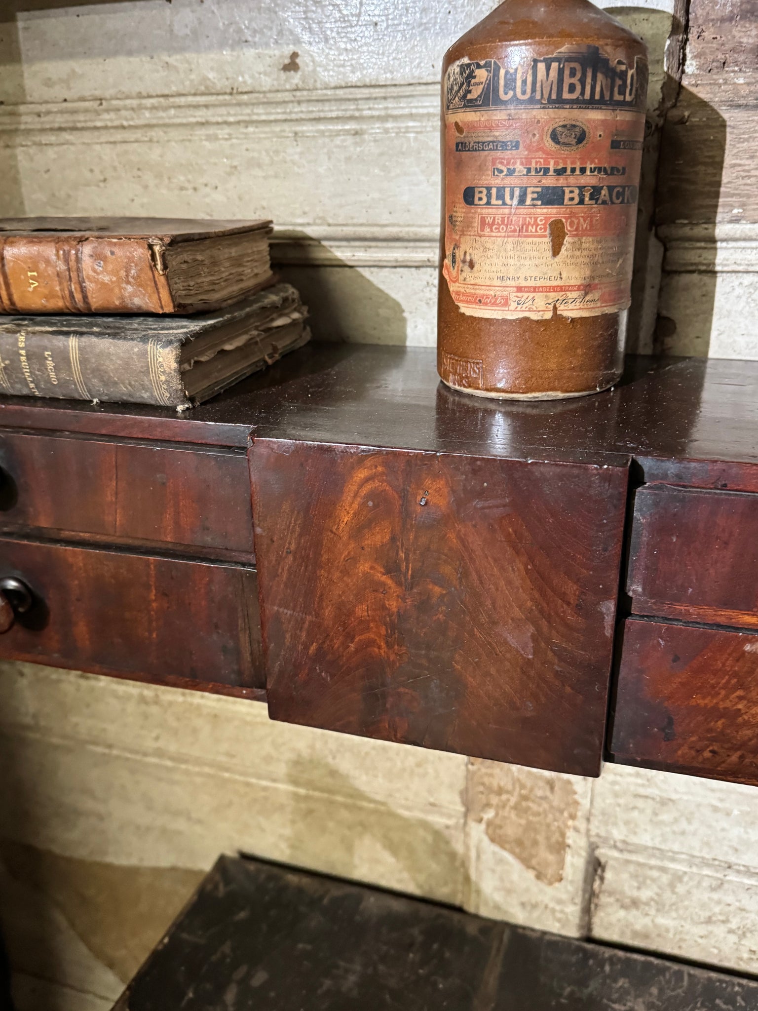 A 19th century set of mahogany apothecary wall shelves with original labels to drawer interiors