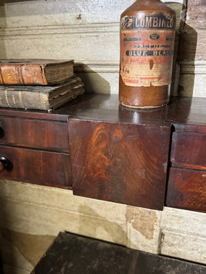 A 19th century set of mahogany apothecary wall shelves with original labels to drawer interiors